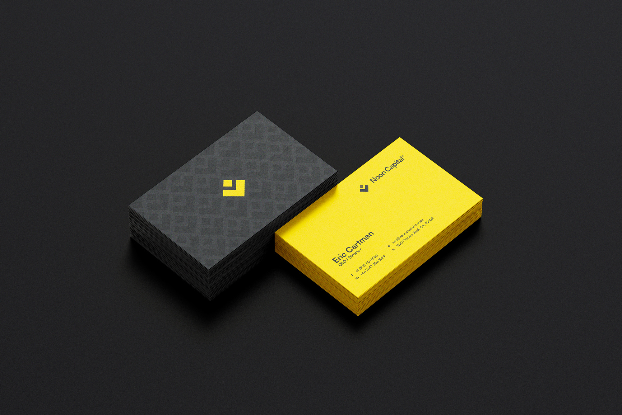Noon Capital — business cards, one charcoal with the brand pattern and one yellow