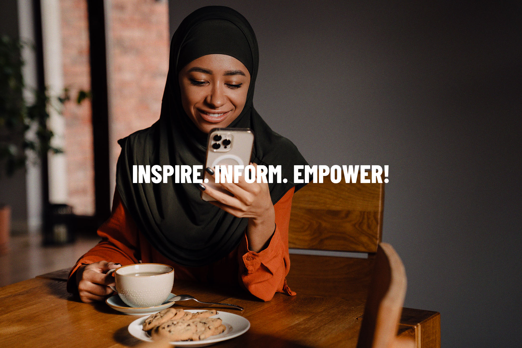 The Muslim Vibe — a phone showing the line “INSPIRE. INFORM. EMPOWER!”