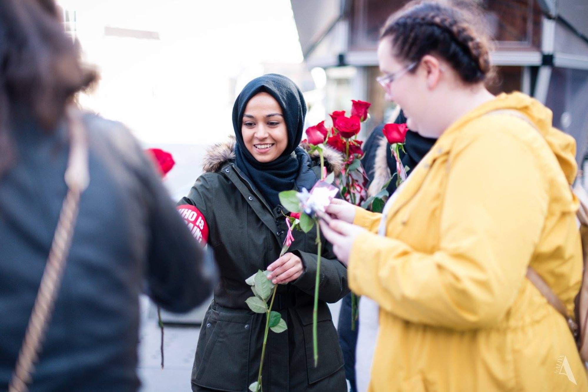 Who is Hussain — volunteers handing out roses on the street